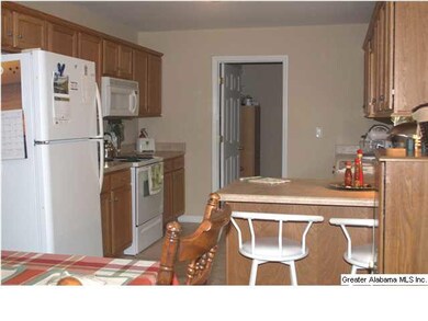 PRETTY CABINETS WITH BREAKFAST BAR AND LAUNDRY ROO