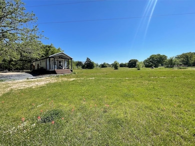 View of grassy yard with a view of rural / pastoral area and a porch