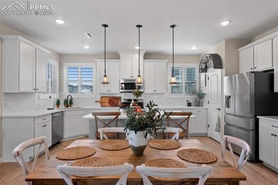 Kitchen featuring appliances with stainless steel finishes, a healthy amount of sunlight, sink, and light hardwood / wood-style floors