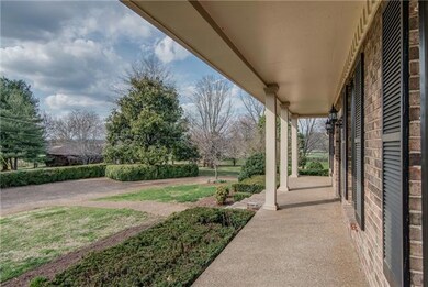 Rocking chair front porch overlooks cul-de-sac on the all brick ranch with full finished basement.