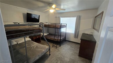 Bedroom featuring a ceiling fan and baseboards