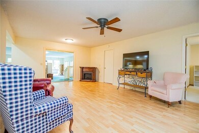 Living room looking into the sunroom at the back. The portable fireplace does not convey with the house.