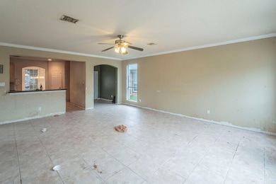 Spare room featuring arched walkways, a ceiling f