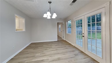 Unfurnished dining area with an inviting chandelie