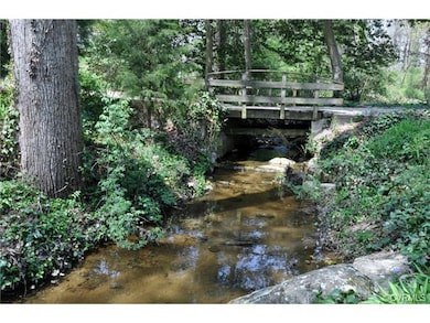 View of brook with bridge in background