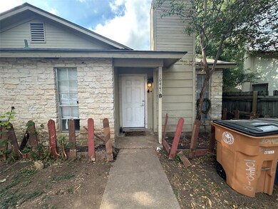 Entrance to property featuring stone siding