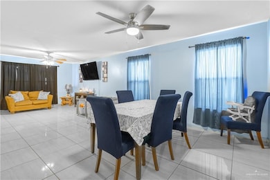 Dining space featuring a ceiling fan, plenty of natural light, and light tile patterned floors