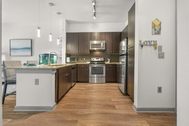 Kitchen with stainless steel appliances, a sink, 