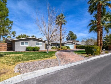 Real grass , mature palms, circular paver drive an