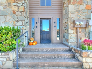 Doorway to property with stone siding