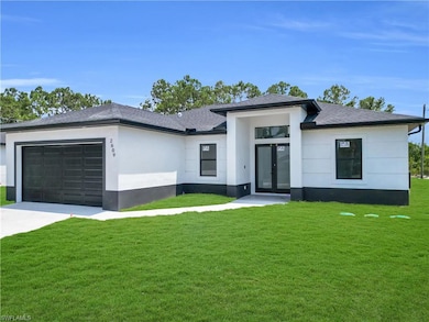 Prairie-style home with french doors, stucco siding, an attached garage, and a front yard