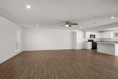 The living room is located next to the kitchen to provide that open concept feel