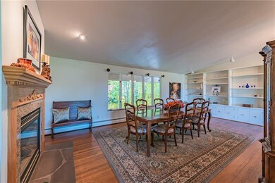 Large dining area for family gatherings with built ins and a double sided fireplace.