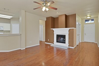 Unfurnished living room featuring ceiling fan and 