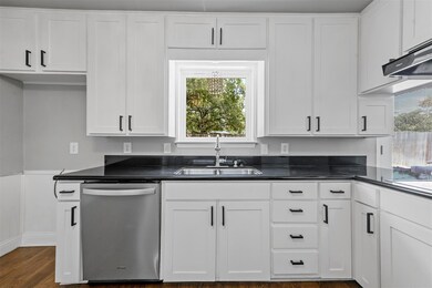 Kitchen featuring sink, dark hardwood / wood-style