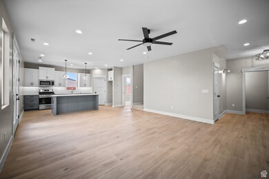 Unfurnished living room with recessed lighting, light wood-style floors, and ceiling fan