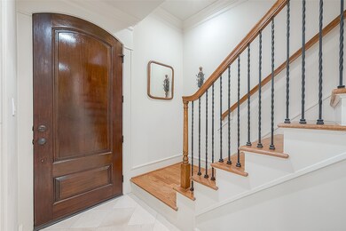 This entryway features a robust wooden front door