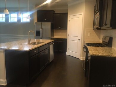 Kitchen with center island, stainless appliances and walk in pantry