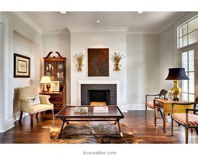 Living Room. This formal living room with fireplace opens to the foyer and formal dining room.  A beautiful view of the back yard and golf course can be seen from the floor to ceiling windows encompassing the entire back of the home.