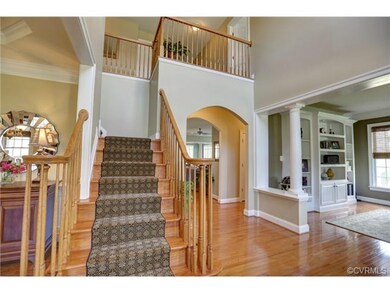 Two-story entry foyer connects to living room and 