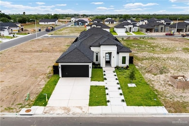 View of front facade with a residential view, a garage, concrete driveway, and a shingled roof