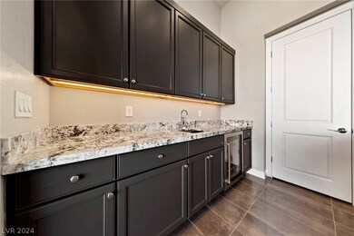 Bar with lighting, wine refrigerator, sink and pan