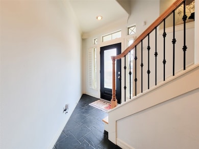 This welcoming tiled entryway features a modern bl