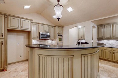 Kitchen with decorative light fixtures, appliances
