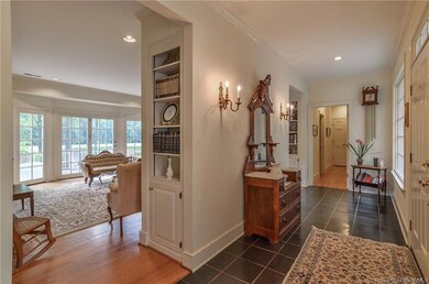 Foyer leads to Formal Living Room with custom buil