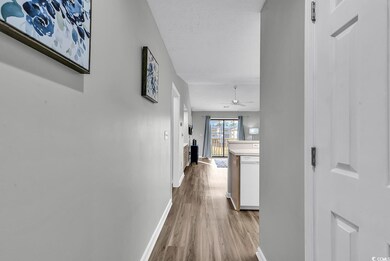 Corridor featuring light wood-type flooring and a 