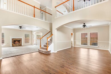 Open View of Foyer, Living Room, Dining Room, and Stairs.