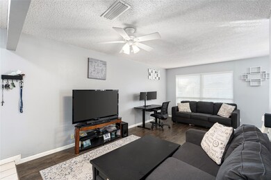 Living room with dark wood-type flooring, ceiling 