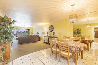 Carpeted dining room with ceiling fan with notable