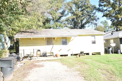 Back of property with a yard