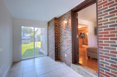 sunroom off living room with access to fenced yard
