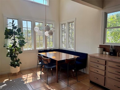 Dining room with light tile patterned floors and baseboards