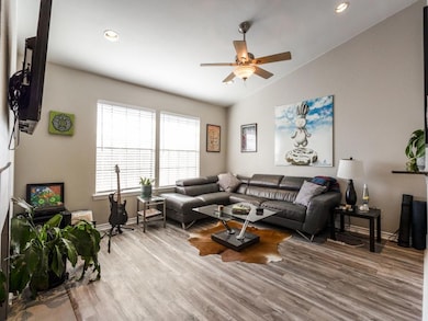 Living room featuring lofted ceiling, light hardwo