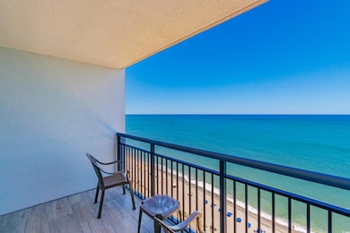 Balcony with view of water and beach