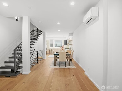 Beautiful, bright dining & kitchen with floating staircase.
