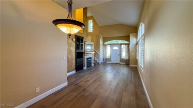 Unfurnished living room with high vaulted ceiling