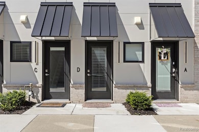 View of front of house with a standing seam roof, a metal roof, and stucco siding