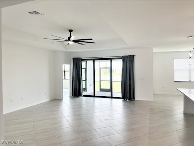 Empty room featuring light tile patterned floors,