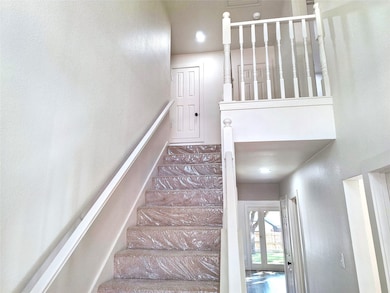 Stairway with recessed lighting and a textured wall