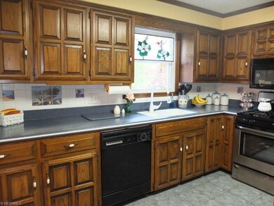 Galehouse kitchen with tile floors and solid surfa