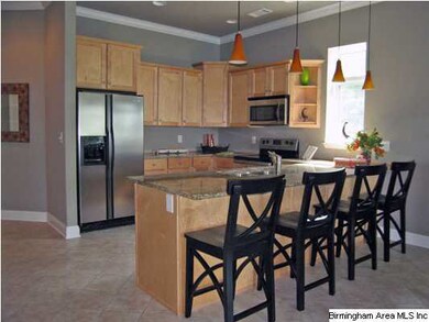 The kitchen has beautiful cabinets and granite cou