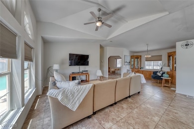 Living area featuring a ceiling fan, lofted ceilin