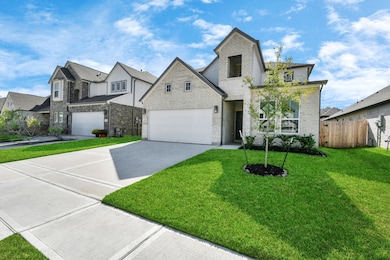 Home features a convenient 2-car garage complemented by a spacious driveway, offering ample parking for you and your guests. Sample photo of completed home with similar floor plan. Actual colors and selections may vary.
