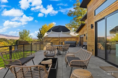 View of patio / terrace with a hot tub and outdoor dining area