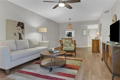 Living room with light wood-type flooring and ceil