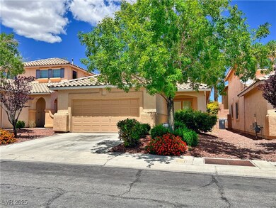 View of front of property with a garage, stucco si